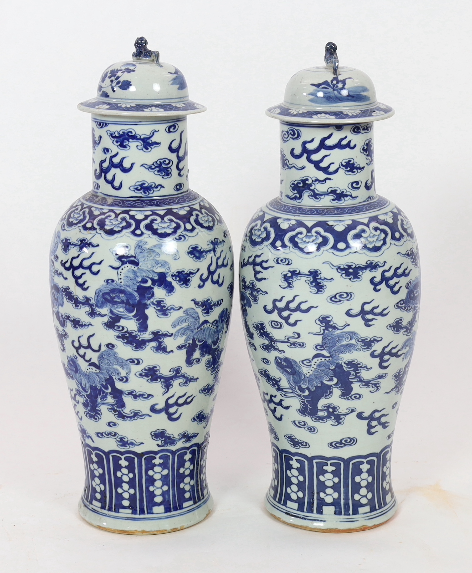 A pair of large Chinese blue and white ‘Buddhist lion’ vases and covers, 19th century, glaze imperfections